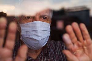 elderly man wearing mask in nursing home